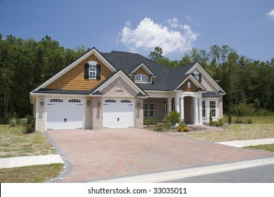 Upscale Home With Brick, Vinyl And Shake Siding With Brick Paver Driveway