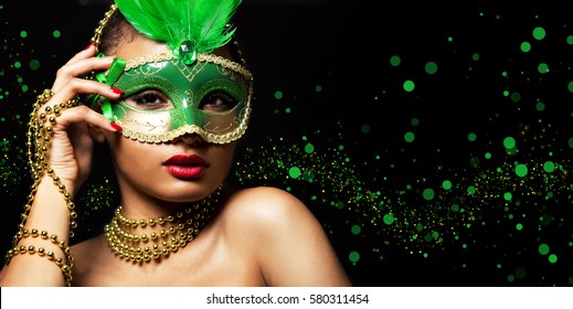 Upscale Indian Woman Wearing Gold Jewellery And Red Lipstick On Black Background. Green Party Mask.