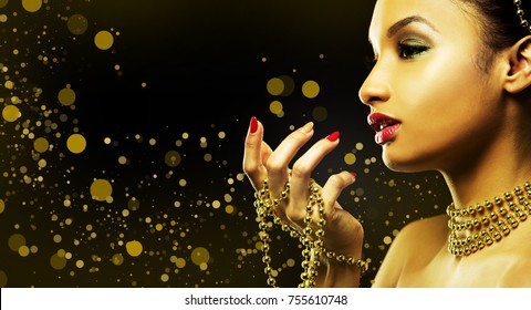 Upscale Indian Woman Wearing Gold Jewellery And Red Lipstick On Golden Background