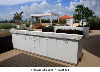 Upscale outdoor cabinets with granite counter top on a rooftop terrace.