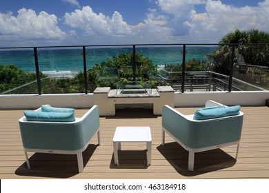 Upscale Outdoor Terrace With Designer Furniture Overlooking The Ocean.