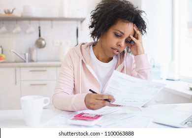 Upset African American Female Sitting At Kitchen Table With Laptop, Dealing With Financial Stress And Pressure Because Of Mortgage Debt, Worrying A Lot Or Feeling Anxious Over Money