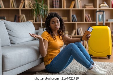 Upset African American Lady Holding Passport With Plane Tickets And Spreading Arms, Being Late For Flight. Young Black Woman Traveling Abroad. Air Flight Journey Concept