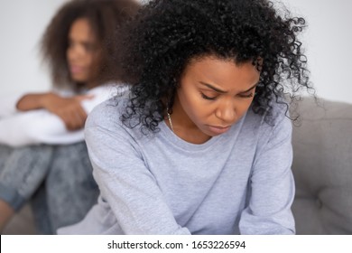 Upset african american mom of difficult teen child puberty daughter feeling offended sad after family fight, depressed single parent black mother thinking of conflict argument with teenage daughter