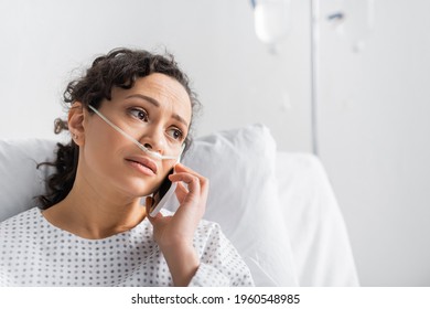 Upset African American Woman Looking Away While Talking On Mobile Phone In Clinic