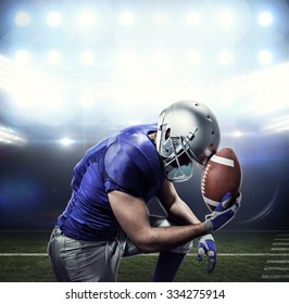 Upset American football player with ball against american football arena - Powered by Shutterstock