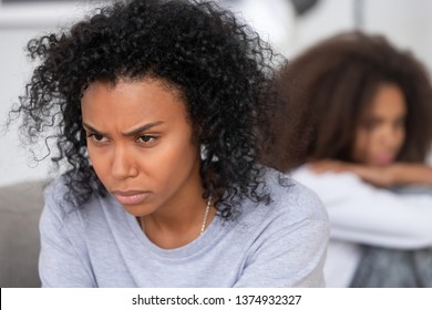 Upset Angry African American Mother Ignoring Teen Daughter After Quarrel, Stubborn Annoyed Mum Not Talking With Teenage Girl After Fight, Family Generation Conflict, Misunderstanding, Close Up