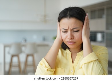 Upset Angry Female Tenant Cover Ears With Hands Ignore Noise At Home. Irritated Frustrated Woman Suffer From Loud Music, Tired From Noisy Neighbors In Apartment. Family Conflict Concept.