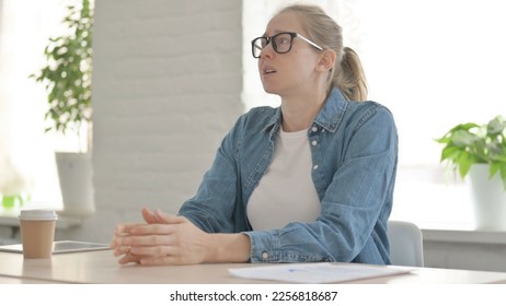 Upset Beautiful Woman Feeling Worried While Sitting in Office - Shutterstock ID 2256818687