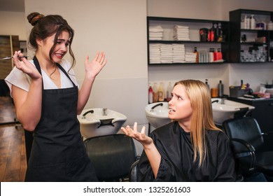 Upset Blonde Young Female Client Blaming Hairdresser As A Haircut Done Bad. Fight In Beauty Salon