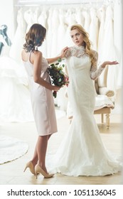 Upset Bride With Friend In Wedding Fashion Shop