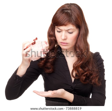 Upset business woman with a piggy bank on white background