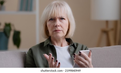 Upset Caucasian Woman Grandmother Elderly Lady With Mobile Phone Feeling Sad Worry Due To Slow Connection Error Online Broken Smartphone Bad News Puzzled With App, Technology And Old Generation