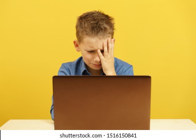 Upset Child Sitting At The Laptop And Crying