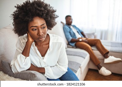 Upset Couple At Home. Handsome Man And Beautiful Young Woman Are Having Quarrel. Sitting On Sofa Together. Family Problems. I Can't Believe We're Fighting About This Again.