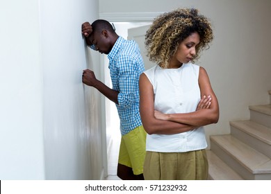 Upset couple ignoring each other after fight at home