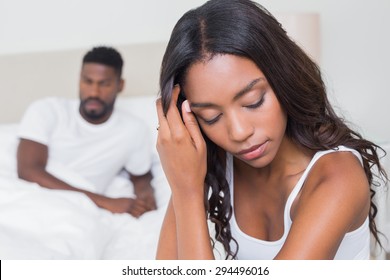 Upset couple not talking to each other after fight at home in bedroom
