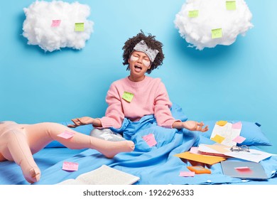 Upset Dark Skinned Woman In Despair Cries As Has Deadline And Much Work Poses On Bed Under Blanket Makes List To Do On Sticky Notes Spends Time Alone At Home Has Imaginary Friend Dressed In Nightwear