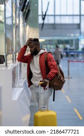 Upset Depressed African American Man With Luggage Standing At Check-in Counter In Airport, Being Sad About Moving Away From Home And Family. Travel And Depression, Pre-travel Anxiety