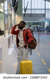 Upset Depressed African American Man With Luggage Standing At Check-in Counter In Airport, Being Sad About Moving Away From Home And Family. Travel And Depression, Pre-travel Anxiety