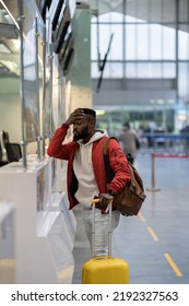 Upset Depressed African American Man With Luggage Standing At Check-in Counter In Airport, Being Sad About Moving Away From Home And Family. Travel And Depression, Pre-travel Anxiety