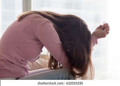 Upset Depressed Young Woman Holding Wedding Ring Indoors, Breaking Off Engagement, Ending Relationship, Abandoned Wife, Cheated Bride Making Hard Decision, Broken Heart, Breakup And Divorce Concept 