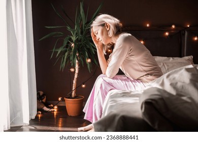 Upset distressed middle aged woman sit on floor in bedroom cry having emotional personal problems breakup or divorce, depressed sad female feel down stressed suffer from infertility or depression  - Powered by Shutterstock