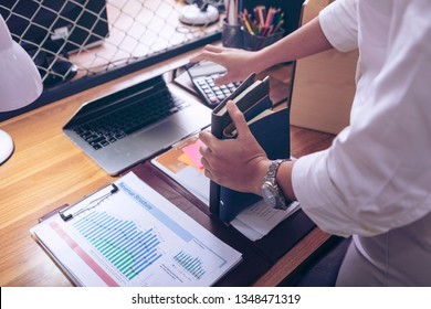 Upset Female Employee Packing Belongings In Box, Frustrated Stressed Girl Getting Fired From Job Ready To Leave On Last Day At Work. Sad Office Worker Desperate From Work
