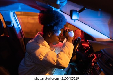 Upset Frustrated African American Girl Sitting In Car With Head On Steering Wheel Feeling Emotional Burnout After Work, Tired Black Woman Driver Making Stop On Road At Night For Napping Sleeping