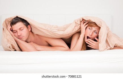 Upset Frustrated And Bored Couple Lying In Bed Having No Sex