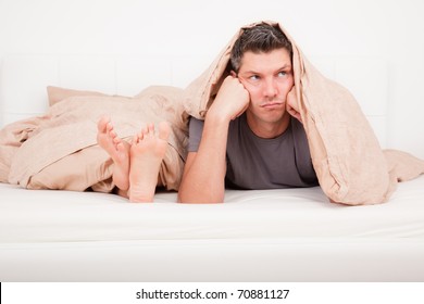 Upset Frustrated And Bored Couple Lying In Bed Having No Sex