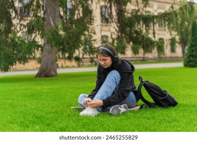 An upset girl student sits near the college with her head down. - Powered by Shutterstock