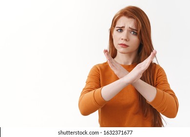 Upset gloomy redhead sad woman with red long hair asking please stop, frowning distressed, make cross with refusal or rejection meaning, begging quit drinking, standing white background uneasy - Shutterstock ID 1632371677