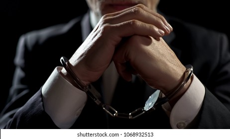 Upset handcuffed man imprisoned for financial crime, punished for serious fraud