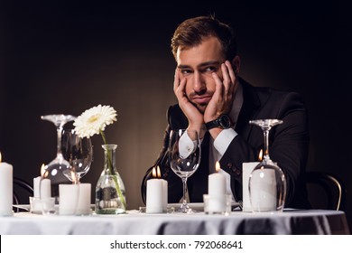 Upset Handsome Man Waiting For Romantic Date In Restaurant 