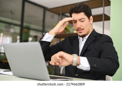 Upset Latin Male Office Employee Looking At The Watch And Checking Time, Missed Important Meeting, Has Deadline With Project, Forgot About Appointment