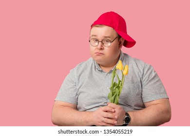 Upset Lover Or Broken Hearted Man With Flowers Thinking Of Revenge Isolated Over Pink Background