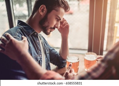 Upset Man In Bar. Friend's Support.