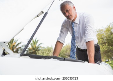 Upset Man Checking His Car Engine After Breaking Down On The Road