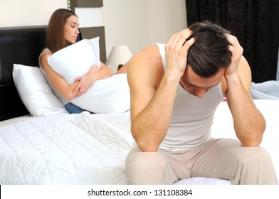 Upset Man Having Problem Sitting On The Bed With His Girlfriend