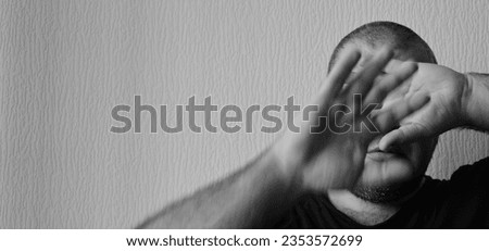 Similar – Desperate man hides eyes behind his hand