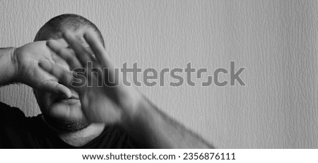 Similar – Desperate man hides eyes behind his hand