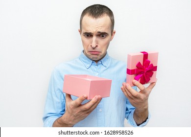 Upset Man With Opened Gift Box, White Background, Concept Of Bad Gifts For Holidays