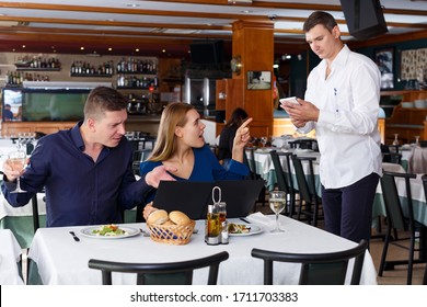 Upset Man And Woman Dissatisfied With Customer Service Of Restaurant