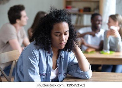 Upset Mixed Race Woman Offended, Ignored By Friends, Feeling Unhappy, Sitting Alone In Cafe, Suffering From Bullying Or Racial Discrimination, Teenager Problem, Gossips, Bad Friendship Concept