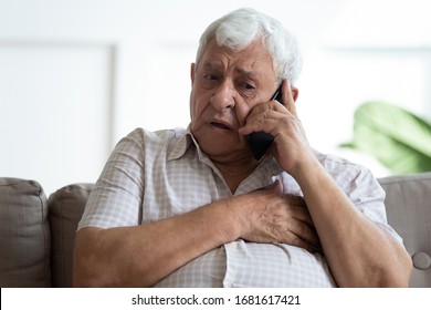 Upset Older Man Touching Chest, Calling Emergency, Talking On Phone, Unhappy Mature Male Having Heart Attack, Lonely Grandfather Suffering From Heartache Disease At Home, Feeling Pain, Sitting Alone