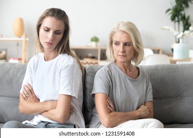 Upset Older Mother In Law And Adult Daughter Sit Back To Back Not Talking After Fight Disagreement, Two Stubborn Old Young Women Ignoring Avoiding Each Other Sad By Argument, Family Conflict Concept