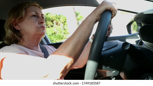 
Upset Older Woman Driving. Angry Senior Lady Driver Holding Steering Wheel