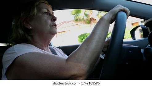 
Upset Older Woman Driving. Angry Senior Lady Driver Holding Steering Wheel