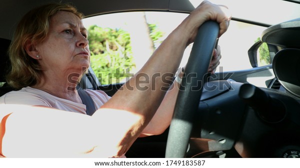 \
Upset older woman driving. Angry senior lady\
driver holding steering\
wheel